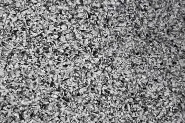 Close-up of grey, black and white epoxy flake chips on a finished garage floor